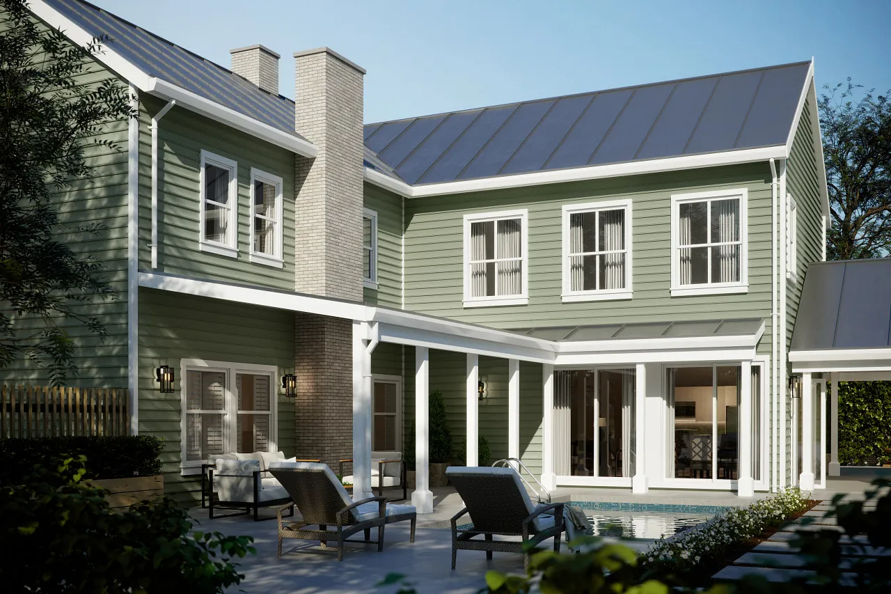 Modern two-story green house with white trim, a patio with lounge chairs, and a small pool in the backyard.